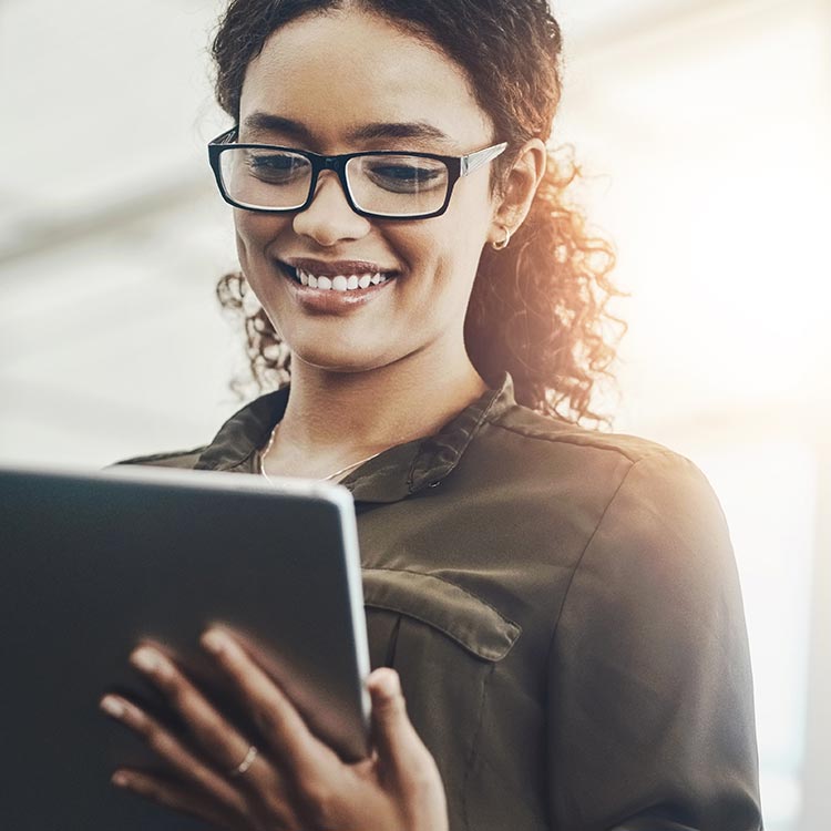 smiling woman reading something on her tablet