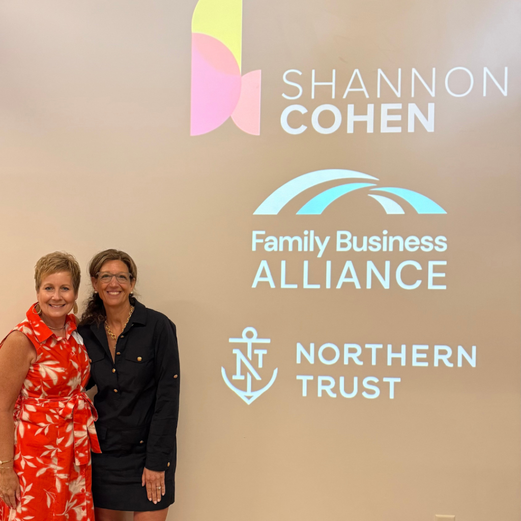 Sheri and Shannon in front of a screen with the Family Business Alliance and Northern Trust logos.